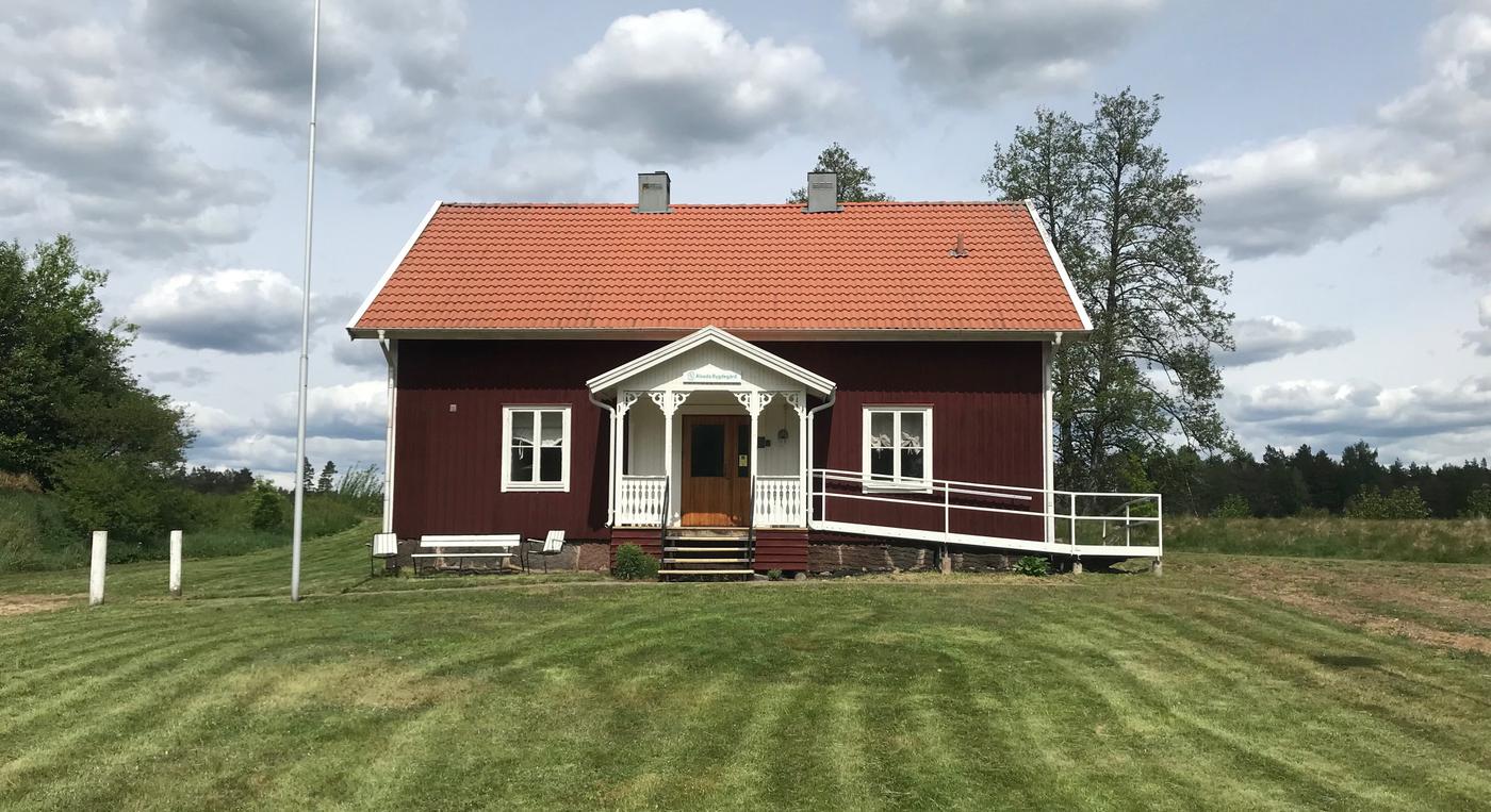 Ett rött hus i lantlig miljö.