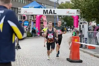 Tre löpare är på väg i mål vid en löpartävling