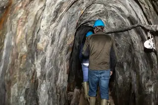 En grupp människor går genom en gruvgång